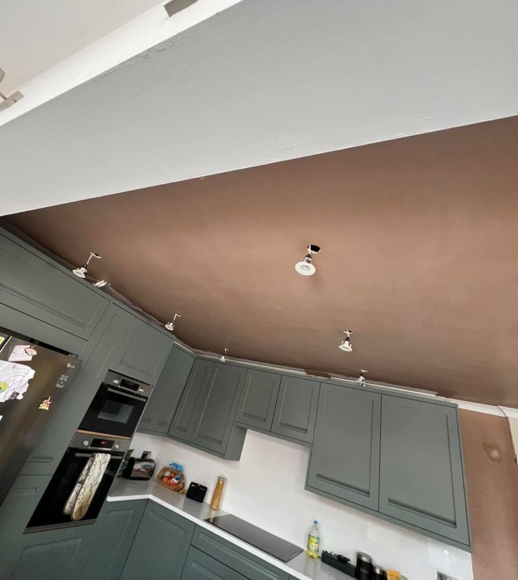 After: the same kitchen ceiling freshly skimmed, still drying